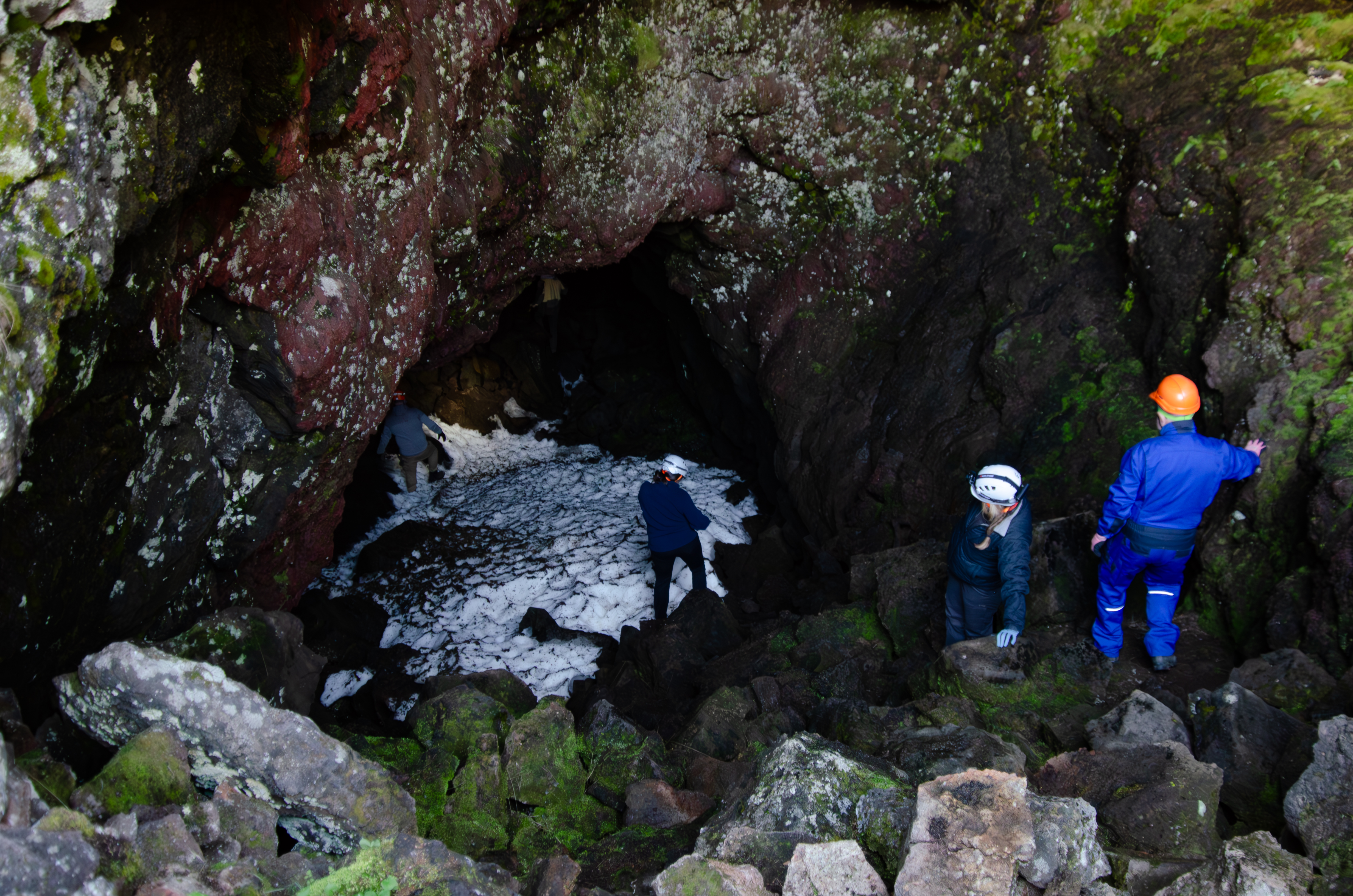 Team entering Lofthellir lava cave with ice inside